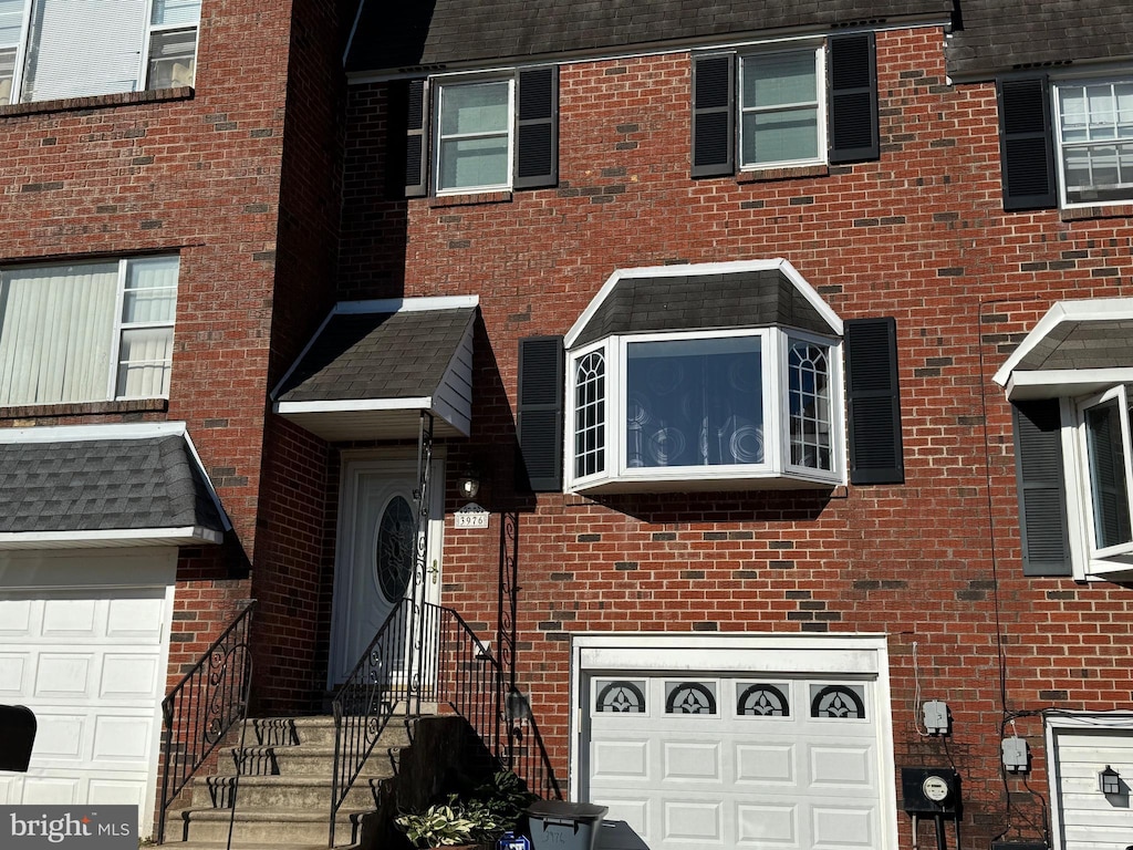 3976 Carteret Dr, Philadelphia, PA 19114 - view of front of home featuring a garage and brick siding