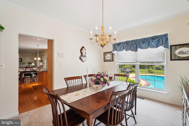 19655 Smith Cir, Ashburn, VA 20147 - dining room with a chandelier, ornamental molding, light colored carpet, and baseboards
