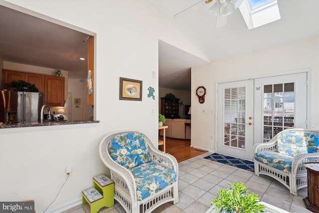 19655 Smith Cir, Ashburn, VA 20147 - living room with lofted ceiling, a ceiling fan, light tile patterned flooring, french doors, and a skylight