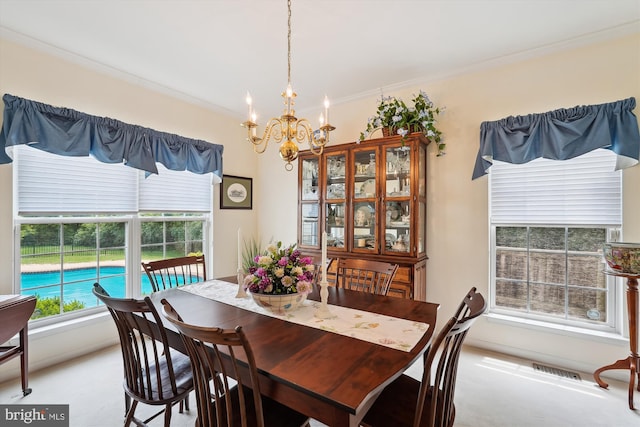 19655 Smith Cir, Ashburn, VA 20147 - dining room featuring a chandelier, crown molding, and light colored carpet