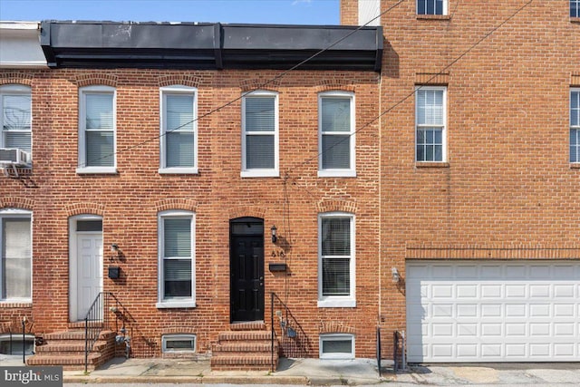 616 Hyson St, Baltimore, MD 21230 - townhome / multi-family property with entry steps, brick siding, and an attached garage