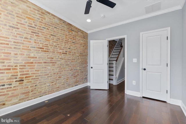 616 Hyson St, Baltimore, MD 21230 - unfurnished bedroom featuring brick wall, a walk in closet, ornamental molding, wood finished floors, and recessed lighting