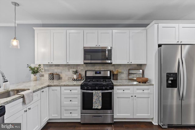 616 Hyson St, Baltimore, MD 21230 - kitchen with stainless steel appliances, crown molding, white cabinets, backsplash, and light stone countertops
