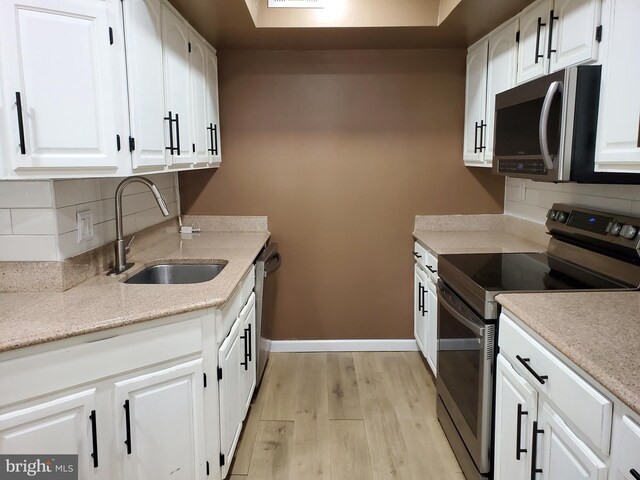 115 Kings Hwy Unit # 196, Maple Shade, NJ 08052 - kitchen featuring appliances with stainless steel finishes, a sink, light wood finished floors, and tasteful backsplash