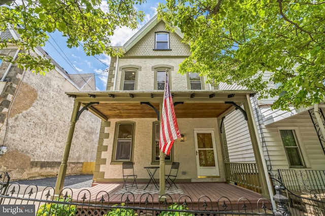 view of front of property featuring stucco siding and covered porch