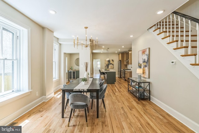 dining room featuring a chandelier, stairs, healthy amount of natural light, and recessed lighting