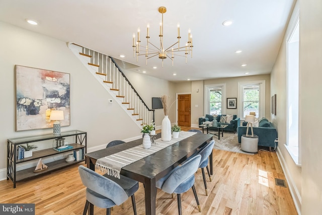 dining area with stairs, light wood-type flooring, recessed lighting, baseboards, and a chandelier