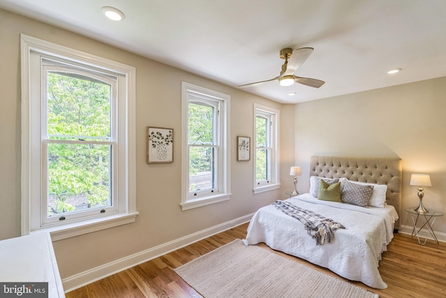 bedroom with baseboards, wood finished floors, ceiling fan, and recessed lighting