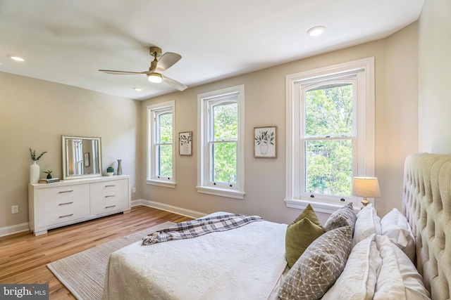 bedroom with light wood-style floors, baseboards, ceiling fan, and recessed lighting