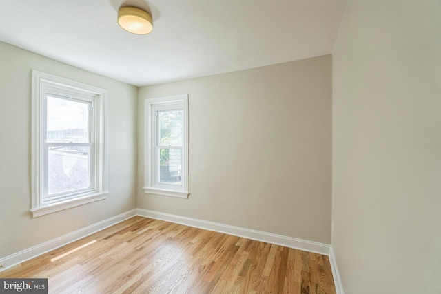 empty room featuring baseboards and light wood-style floors