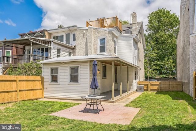 back of property with a patio area and a chimney