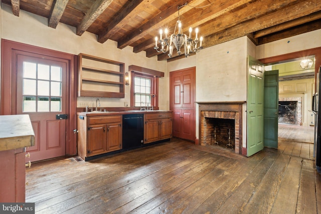 501 Stone Chapel Rd, Westminster, MD 21157 - kitchen with dishwasher, dark wood-type flooring, a brick fireplace, a sink, and a chandelier