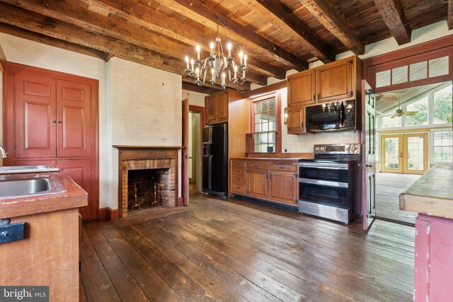 501 Stone Chapel Rd, Westminster, MD 21157 - kitchen featuring black appliances, a sink, a chandelier, a brick fireplace, and wood ceiling with exposed beams