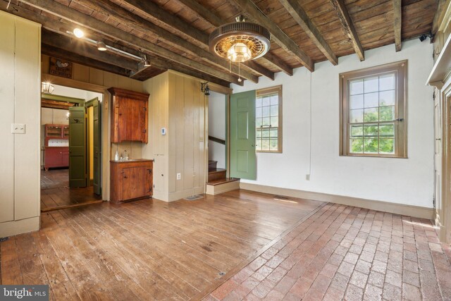 501 Stone Chapel Rd, Westminster, MD 21157 - unfurnished living room featuring wooden ceiling with exposed beams, stairway, plenty of natural light, and baseboards
