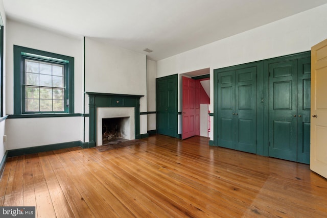 501 Stone Chapel Rd, Westminster, MD 21157 - unfurnished living room with light wood-style floors, a fireplace, and baseboards