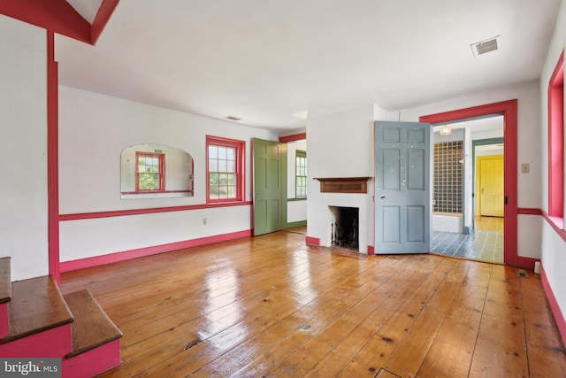 501 Stone Chapel Rd, Westminster, MD 21157 - unfurnished living room with a fireplace, hardwood / wood-style floors, and baseboards