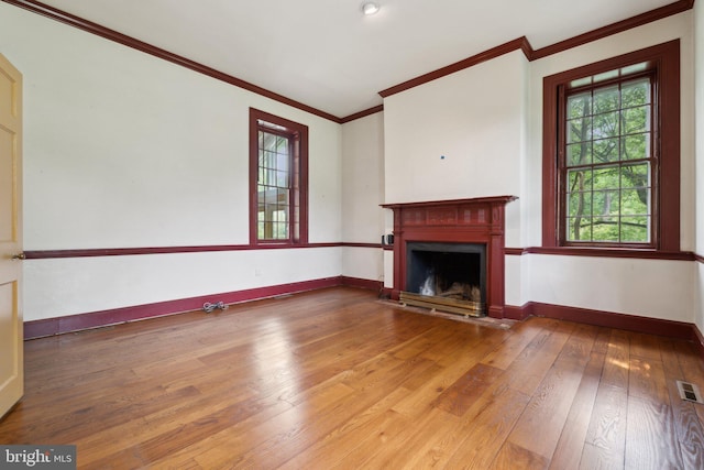 501 Stone Chapel Rd, Westminster, MD 21157 - unfurnished living room with crown molding, wood-type flooring, healthy amount of natural light, a fireplace, and baseboards