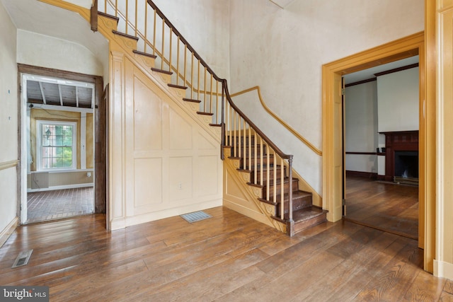 501 Stone Chapel Rd, Westminster, MD 21157 - stairs with wood-type flooring, a fireplace with raised hearth, and baseboards