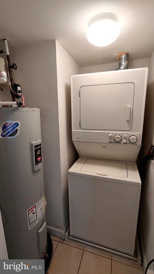 33 Owens Landing Ct Unit 33C, Perryville, MD 21903 - washroom featuring stacked washer and clothes dryer, water heater, and tile patterned flooring
