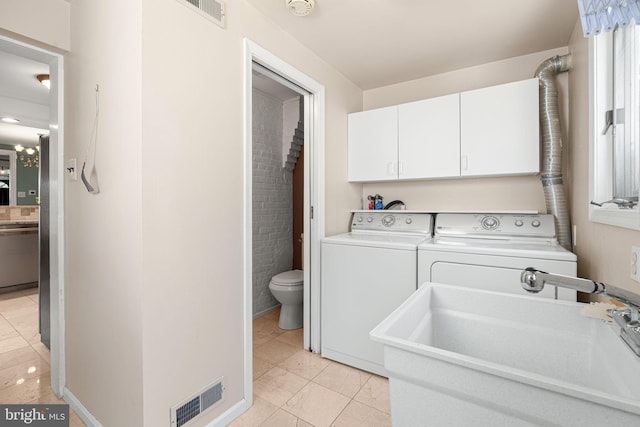 836 N 25th St, Philadelphia, PA 19130 - laundry room with cabinet space, separate washer and dryer, and light tile patterned flooring