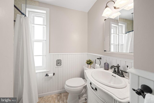 836 N 25th St, Philadelphia, PA 19130 - bathroom with wainscoting, toilet, vanity, and a shower with shower curtain