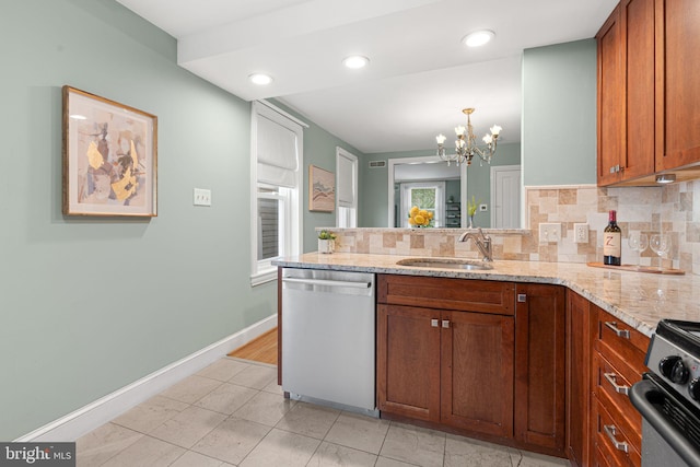 836 N 25th St, Philadelphia, PA 19130 - kitchen featuring stainless steel dishwasher, a sink, a peninsula, brown cabinetry, and recessed lighting