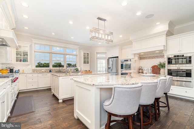 12 Sagecrest Cir, Enola, PA 17025 - kitchen with a center island, a warming drawer, ornamental molding, tasteful backsplash, and stainless steel appliances