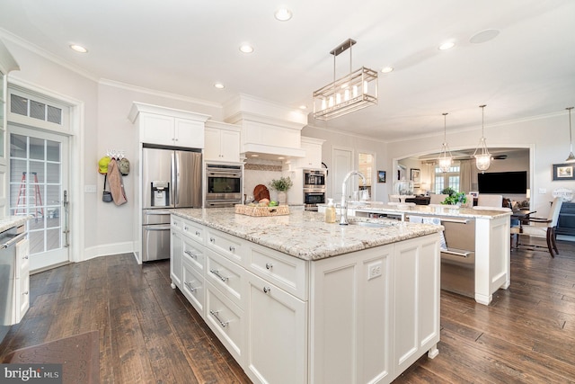 12 Sagecrest Cir, Enola, PA 17025 - kitchen with an island with sink, appliances with stainless steel finishes, white cabinets, crown molding, and dark wood-style floors