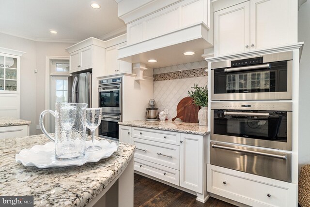 12 Sagecrest Cir, Enola, PA 17025 - kitchen featuring a warming drawer, double oven, tasteful backsplash, white cabinetry, and crown molding