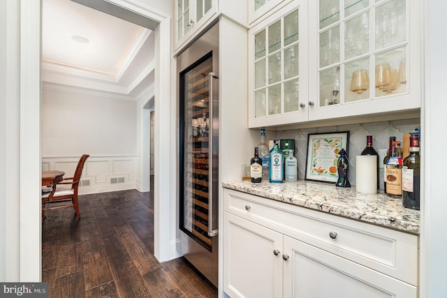 12 Sagecrest Cir, Enola, PA 17025 - indoor dry bar featuring dark wood-style flooring, crown molding, a tray ceiling, beverage cooler, and a wainscoted wall
