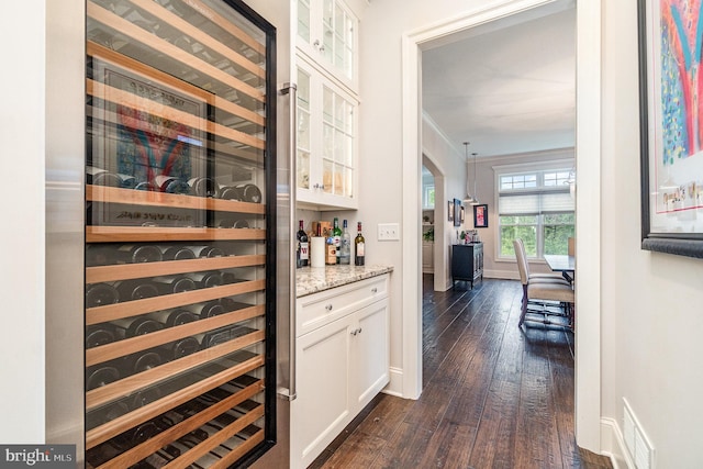 12 Sagecrest Cir, Enola, PA 17025 - bar with beverage cooler, dark wood finished floors, baseboards, and arched walkways