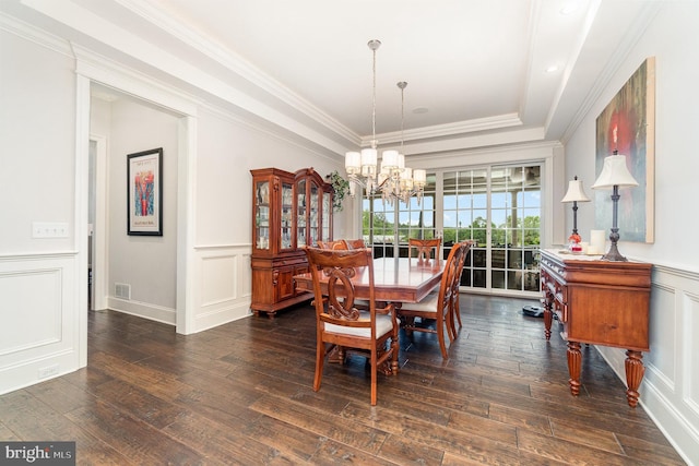 12 Sagecrest Cir, Enola, PA 17025 - dining space with a chandelier, a decorative wall, dark wood-style flooring, a raised ceiling, and wainscoting
