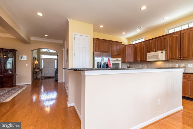 39 Nathaniel, Holland, PA 18966 - kitchen featuring white appliances, ornamental molding, arched walkways, recessed lighting, and light wood-style floors