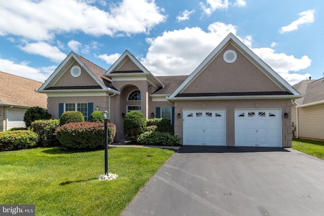 39 Nathaniel, Holland, PA 18966 - view of front of property with asphalt driveway, a front yard, stucco siding, and a garage