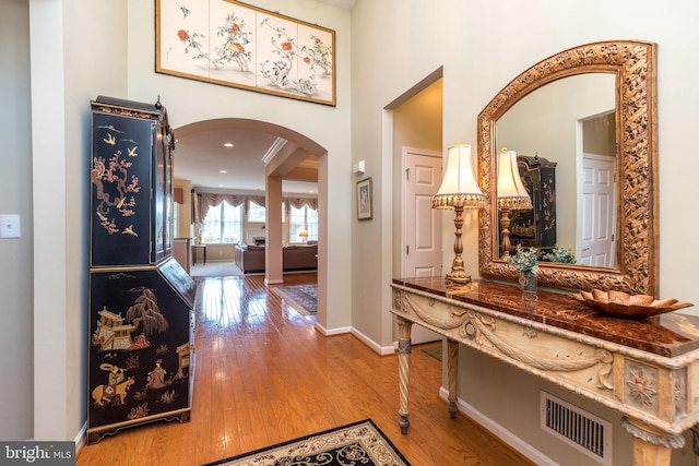 39 Nathaniel, Holland, PA 18966 - hallway with arched walkways, wood finished floors, baseboards, and a towering ceiling