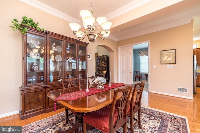39 Nathaniel, Holland, PA 18966 - dining space featuring arched walkways, a chandelier, crown molding, light wood-style flooring, and baseboards