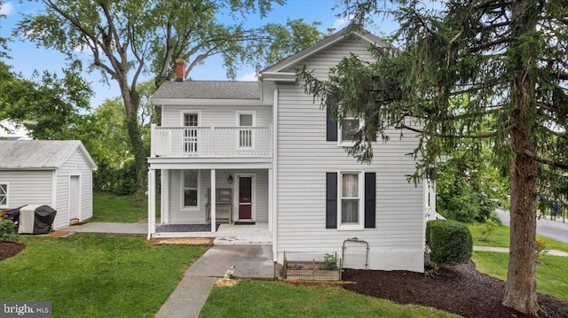 116 W 17th St, Front Royal, VA 22630 - view of front of home with a balcony, a front yard, covered porch, and a chimney