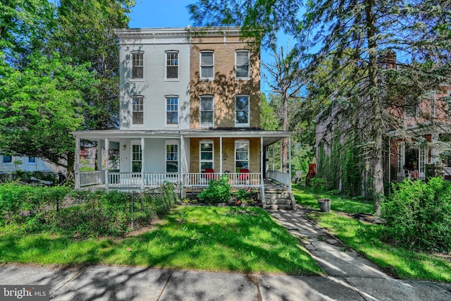 109 S Augusta Ave, Baltimore, MD 21229 - italianate house with covered porch, a front lawn, and brick siding