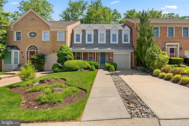 12125 Gatewater Dr, Potomac, MD 20854 - view of front facade with driveway, brick siding, and covered porch