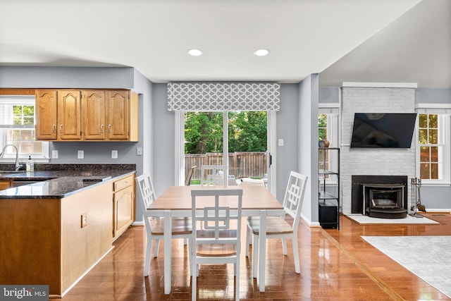 12125 Gatewater Dr, Potomac, MD 20854 - kitchen featuring healthy amount of natural light, wood finished floors, dark stone countertops, and recessed lighting