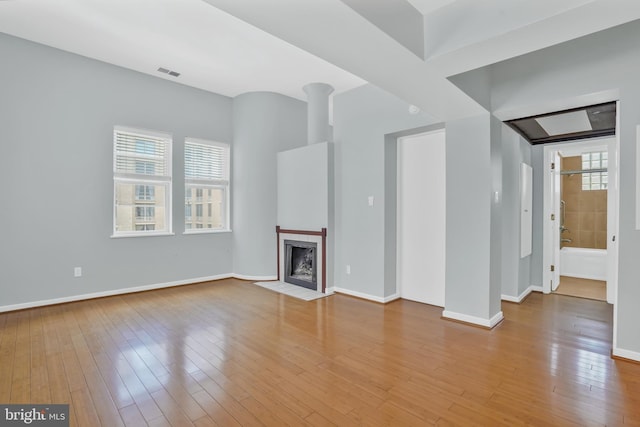 2114 N St NW Unit 46, Washington, DC 20037 - unfurnished living room with wood-type flooring, baseboards, and a fireplace with flush hearth