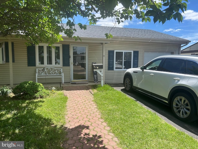 44 Sugarmaple Ln, Levittown, PA 19055 - view of front of home featuring an attached garage and roof with shingles