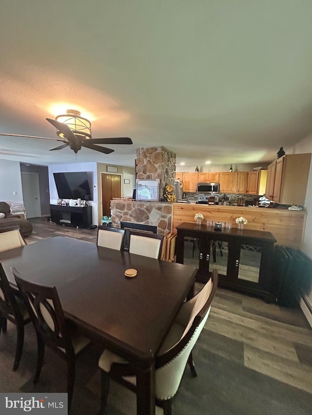 44 Sugarmaple Ln, Levittown, PA 19055 - dining area featuring ceiling fan, a stone fireplace, and wood finished floors