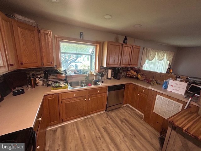 44 Sugarmaple Ln, Levittown, PA 19055 - kitchen with stainless steel dishwasher, light wood-style flooring, light countertops, and plenty of natural light