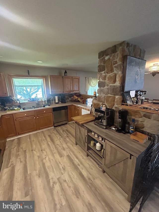 44 Sugarmaple Ln, Levittown, PA 19055 - kitchen featuring stainless steel dishwasher, light wood-style flooring, a sink, tasteful backsplash, and light countertops