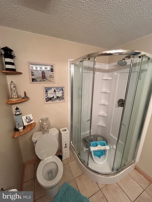 44 Sugarmaple Ln, Levittown, PA 19055 - full bathroom featuring tile patterned floors, a stall shower, a textured ceiling, and toilet