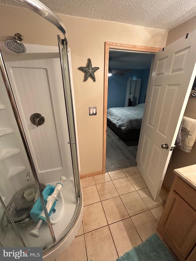 44 Sugarmaple Ln, Levittown, PA 19055 - full bathroom featuring a shower stall, a textured ceiling, tile patterned flooring, and vanity