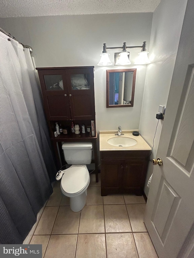 44 Sugarmaple Ln, Levittown, PA 19055 - bathroom featuring tile patterned flooring, a textured ceiling, toilet, and vanity