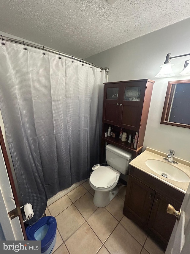 44 Sugarmaple Ln, Levittown, PA 19055 - full bath featuring a textured ceiling, tile patterned flooring, toilet, and vanity