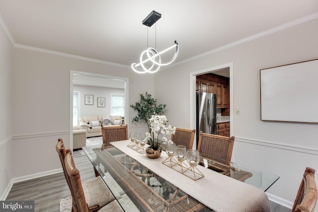 5183 Silver Run Ln, Salisbury, MD 21801 - dining space featuring crown molding, light wood-type flooring, baseboards, and a chandelier